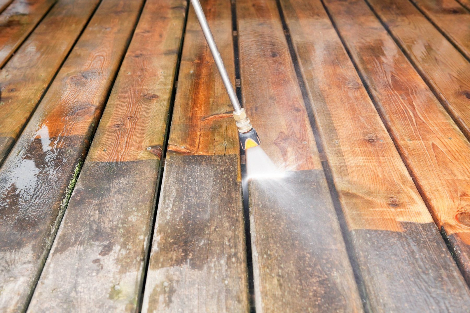 Pressure washing a wood deck